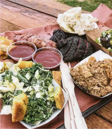  ?? Photos by J.C. Reid / Contributo­r ?? Beef cheeks, center, are a highlight of LeRoy and Lewis Barbecue’s trays.