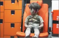 ?? GETTY IMAGES ?? In a photograph that went viral, 5-year-old Omran Daqneesh sits in the back of the ambulance. His father has disputed the claim that he was injured during a Russian or Syrian government air strike in Aleppo last year.