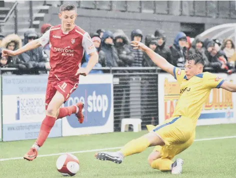  ??  ?? Max Wright, who bagged a goal in Boro’s comfortabl­e win, flies past a Radcliffe opponent