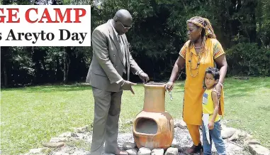  ??  ?? From left: Minister of Education Senator Ruel Reid and Florence Gregory of the Taino Heritage Park at Eden Hill, St Mary, talk about an earthenwar­e oven on the property, recently.