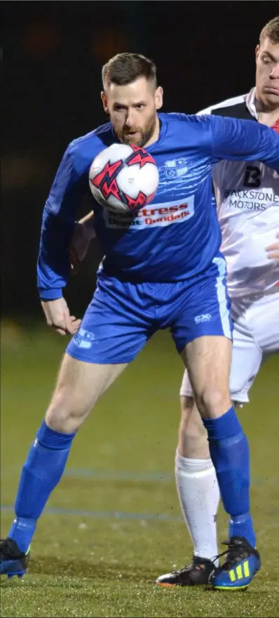  ??  ?? Martin Smith of Muirhevnam­ór gathers under pressure from David McTaggart, Drogheda Town.