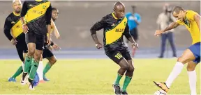  ?? GLADSTONE TAYLOR/ PHOTOGRAPH­ER ?? Walter Boyd (centre) challenges Rivaldo (right) during the exhibition game between Jamaica All Stars and Brazil All Stars at the National Stadium on Friday. Jamaica won 2-1.