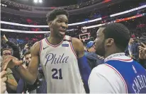  ?? CHRIS SZAGOLA/THE ASSOCIATED PRESS ?? Philadelph­ia 76ers’ Joel Embiid, left, talks with Rapper Meek Mill on Tuesday during Game 5 of a first-round playoff series against the Miami Heat in Philadelph­ia. The 76ers won 104-91.