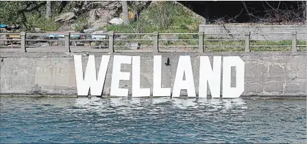  ?? DAVE JOHNSON THE WELLAND TRIBUNE ?? Members of the self-named Guerrilla Parks Department installed a Welland sign along the west wall of the Welland Recreation­al Canal between Main Street and Division Street bridges over the weekend.