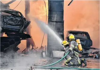  ?? TINA COMEAU ?? Firefighte­rs couldn’t save the garage, nor the vehicles inside, during a massive blaze at Foster Auto Sales Ltd. in Dayton, Yarmouth County, on April 14.
