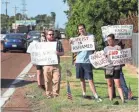  ??  ?? From left, William Justice, Daniel Wallace and Lorin Vincent hold signs along Summer Avenue near a federal immigratio­n facility to protest the separation of children from parents. BRAD VEST / THE COMMERCIAL APPEAL