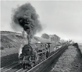  ?? MORTONS RAILWAY MAGAZINE ARCHIVE/J. R. CARTER. ?? Right: Note the retained smokebox as an ex-Crosti-boilered 9F 2-10-0 heads a northbound freight to Carlisle through Scout Green on April 2, 1965.