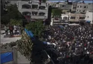  ?? (AP/Fatima Shbair) ?? Mourners pray for 21 members of the Palestinia­n Abu Raya family who died in a fire in their apartment building on Friday in the Jebaliya refugee camp, northern Gaza Strip.