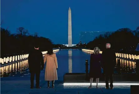  ?? Evan Vucci / Associated Press ?? President-elect Joe Biden and his wife, Jill, are joined by Vice President-elect Kamala Harris and her husband Doug Emhoff at an event at the Lincoln Memorial Reflecting Pool to honor those who have died of COVID-19.