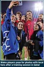  ?? ?? Wales players pose for photos with local fans after a training session in Qatar