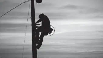  ?? [PHOTOS PROVIDED BY OKLAHOMA ELECTRIC COOPERATIV­E] ?? An Oklahoma Electric Cooperativ­e lineman climbs a pole.