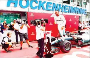  ?? AFP ?? Mercedes driver Lewis Hamilton celebrates after winning the German Grand Prix at the Hockenheim racing circuit on Sunday in Hockenheim, southern Germany.