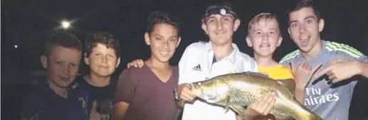  ??  ?? Themeli Vrondos and his mates celebrated his birthday by catching a 68cm barra from Durack Lakes