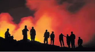  ??  ?? Tourists get a look at the Erta Ale volcano in Ethiopia.