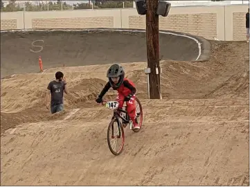  ?? PHOTOS BY JENNIE BLEVINS — ENTERPRISE-RECORD ?? BMX rider Jase Poteet races Sunday at the Silver Dollar BMX Speedway in Chico.