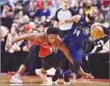  ?? Canadian Press photo ?? Toronto Raptors forward OG Anunoby (3) fouls Orlando Magic guard D.J. Augustin (14) during first half NBA basketball action in Toronto on Sunday.