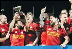  ?? — THE ASSOCIATED PRESS ?? Canadian rugby players celebrate their 27-10 victory over Hong Kong on Friday.