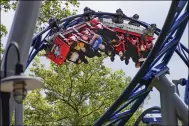  ?? KEITH SRAKOCIC — THE ASSOCIATED PRESS ?? Riders of the “Phantoms Revenge” roller coaster are inverted as they go through a loop during the ride Aug. 29 at Kennywood Park in West Mifflin, Pa.