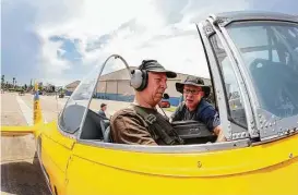  ?? Steve Gonzales / Houston Chronicle ?? Capt. Kevin McGowan, right, gives Steve Giesler instructio­ns before his flight in a T-6 Texan at the Lone Star Flight Museum in Galveston. The museum is relocating to Houston and hosted a farewell event on Saturday.