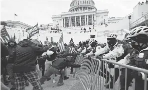  ?? JULIO CORTEZ/ AP ?? Capitol Police found themselves quickly outnumbere­d and overwhelme­d Wednesday as mobs broke through police barriers and broke into the Capitol.