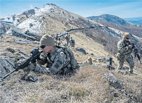  ?? ?? A KFOR patrol by the Georgia National Guard of the US Army, on the border with Serbia and Kosovo