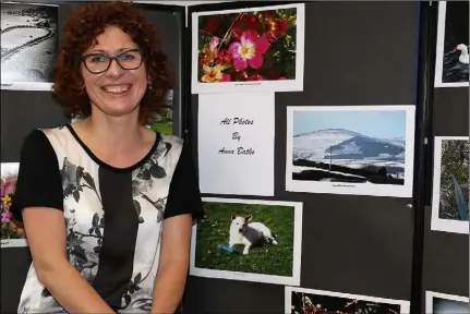  ??  ?? Anna Batko with her photograph­s at the Multi-Cultural Open Day in Bunclody VTOS recently.