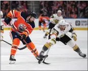  ?? CODIE MCLACHLAN — THE ASSOCIATED PRESS ?? The Oilers’ Kris Russell, left, is checked by the Golden Knights’ William Carrier during the first period of Monday night’s Pacific Division battle in Edmonton.