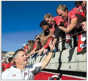  ?? AP file photo ?? Coach Kyle Whittingha­m (lower left) and the Utah Utes have agreed to a two-game series against the University of Arkansas, with the games being played in Salt Lake City in 2026 and in Fayettevil­le in 2028.