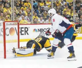  ?? Getty Images ?? The Capitals’ Alex Ovechkin watches the puck hit the post behind Penguins goalie Matt Murray before the Washington forward batted it in for the game-winning goal late in Tuesday night’s game in the Eastern Conference semifinals.