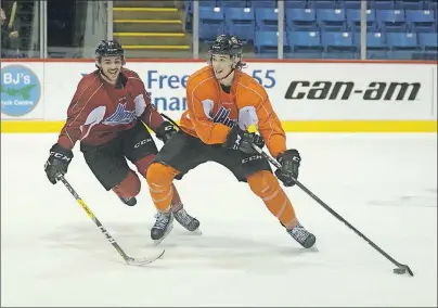  ?? JASON MALLOY/THE GUARDIAN ?? Charlottet­own Islanders left-winger Pascal Aquin, left, tries to get the puck from teammate Francois Beauchemin during a recent practice.