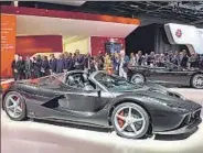  ?? PICS: AP& REUTERS ?? With mayor of Paris Anne Hidalgo keen on banning diesel cars, the city’s auto show seemed an apt place to showcase hybrid vehicles — from supercars to hatchbacks. Clockwise from above: Laferrari Aperta, Toyota’s hydrogen fuelcell Mirai and Vauxhall’s...