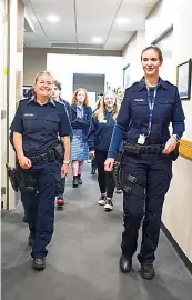  ?? ?? Leading senior constable Paula Fowler and acting sergeant Kiara Roffey lead local students on a tour of Warragul Police Station.