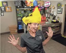  ?? MIKE DE SISTI/ MILWAUKEE JOURNAL SENTINEL ?? Chris Ranson, tours and environmen­tal programmer for Lakefront Brewery, shows off a chicken hat that is sold in the brewery gift shop.