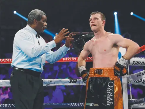  ??  ?? BEATEN: Referee Robert Byrd gives a count to Jeff Horn after he was knocked down by Terence Crawford in the ninth round.