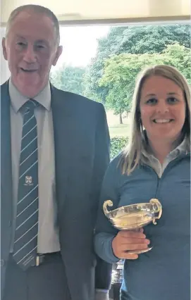  ??  ?? Champ Louise receives her trophy from club captain George Clelland