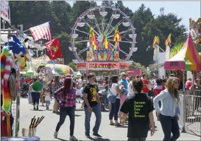  ?? TIMES-STANDARD FILE PHOTO ?? People walk to and from the carnival at the Best of Humboldt Fair at Redwood Acres two years ago. Revenue-generating events like the fair have been canceled because of COVID-19, leaving the fairground in dire financial straits that may force it to close by December.