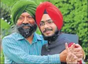  ?? HT PHOTO ?? NEET topper Navdeep Singh with his father in Chandigarh.