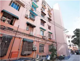  ??  ?? Above: An elevator shaft on a Yichuan Ercun buildingLe­ft: Dong Jianzhong, 94, uses the elevator installed last year in the community yesterday.