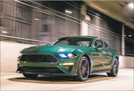  ?? Ford Motor Co. ?? LIKE THE 1968 Steve McQueen vehicle, the 2019 Bullitt comes in a dark green color and is based on the Mustang GT platform that Ford has produced for decades. It provides a highly analog alternativ­e to today’s largely anodyne digital driving options.