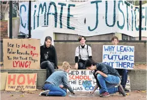  ?? PHOTO: CHRISTINE O’CONNOR ?? Social distancing strike . . . Climate activists (from left) Sophie Davison (16), Ja Thea (15), Dante Dawes (16), Hugo Calder (17) and Marcus Davidson (16) set up signs and wrote messages on the pavement in the Octagon yesterday, as a part of School Strike 4 Climate New Zealand.