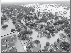  ?? AP/DAVID J. PHILLIP ?? Water from Addicks Reservoir flows into neighborho­ods from floodwater­s brought on by Tropical Storm Harvey on Aug. 29 in Houston.