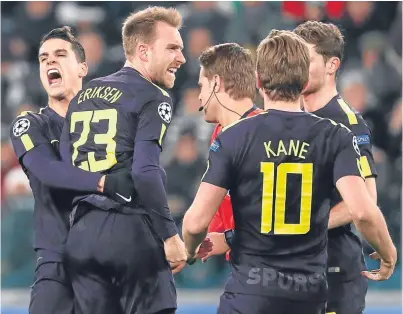 ?? Picture: AP. ?? Christian Eriksen celebrates with his Tottenham teammates after levelling the scores in Turin last night.