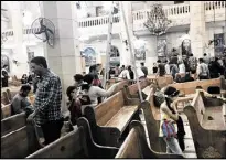  ?? NARIMAN EL-MOFTY / AP ?? People look at damage inside the St. George’s church after a suicide bombing, in the Nile Delta town of Tanta, Egypt, on Sunday.