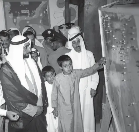  ?? Photos: National Archives ?? Above, UAE Founding Father, the late Sheikh Zayed bin Sultan Al Nahyan, with Sheikh Mohamed, then a pupil, at the open day at Al Kindi Primary School in Abu Dhabi. Sheikh Mohamed’s teacher, Mohamed Al Tamimi is standing behind him. Left, Sheikh Zayed and Sheikh Mohamed attend the final of the Arabian Camel Festival at Al Wathba Racetrack on April 26, 1991