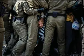  ?? (AP file photo) ?? Police detain demonstrat­ors in Minsk, Belarus, during a September protest against presidenti­al election results. More than 30,000 people have been detained during months of protests.