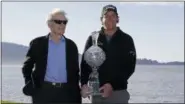  ?? ERIC RISBERG — THE ASSOCIATED PRESS ?? Phil Mickelson poses with his trophy and Clint Eastwood on the 18th green of the Pebble Beach Golf Links after winning the AT&amp;T Pebble Beach Pro-Am golf tournament Monday in Pebble Beach