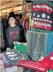  ?? JOELLE KOVACH/ EXAMINER ?? Salesperso­n Halle Magasi shows off deals for Black Friday at The Patch on George St. downtown.