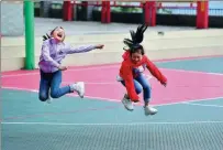  ?? HUANG XIAOBANG / XINHUA ?? Children jump rope on Wednesday on the new playground of a primary school in Rongshui county in the Guangxi Zhuang autonomous region. The school has been extensivel­y upgraded as part of the nation’s poverty relief efforts.