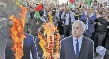  ??  ?? AFP Palestinia­ns burn cutouts of US President Donald Trump, US State Secretary Mike Pompeo, and Israeli Prime Minister Benjamin Netanyahu in ‘day of rage’ protests across the West Bank on November 26, 2019.