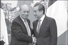  ?? REUTERS ?? French Foreign Affairs minister Jean-Yves Le Drian shakes hands with China’s Foreign Minister Wang Yi after a joint press conference at Diaoyutai State Guesthouse in Beijing, China.